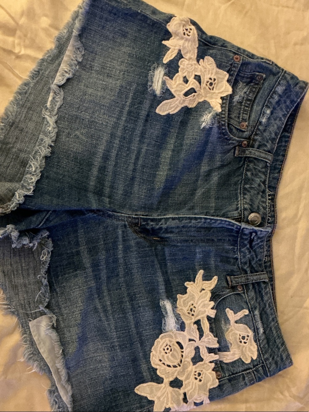 American Eagle Outfitters Blue Denim Shorts with White Floral Appliqué